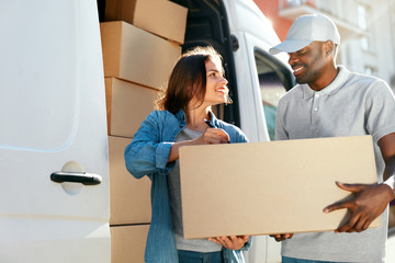 Delivery Service. Courier Delivering Package To Woman Near Car