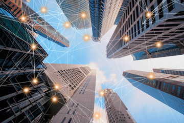 Digital network connection lines of architectures, skyscraper buildings in Singapore City with blue...