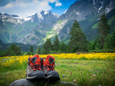 hiking boots and mountains landscape