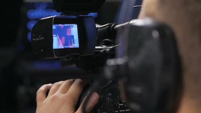 Camera operator working with a cinema broadcast TV camera