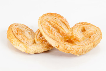 elephant ear, puff pastry cookie. Crispy heart or butterfly or bakery on white background for valentine