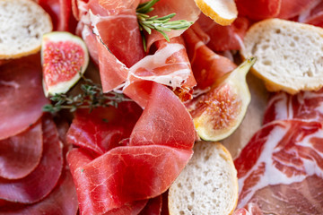 Light Italian snacks. A buffet table at a dinner party. Food tray with delicious salami, pieces of...