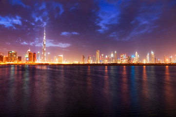 Fototapeta na wymiar Beautiful night dubai downtown skyline. Reflection of skyscrapers in Business Bay area, Dubai, United Arab Emirates