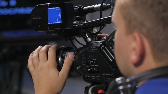 Camera operator working with a cinema broadcast TV camera