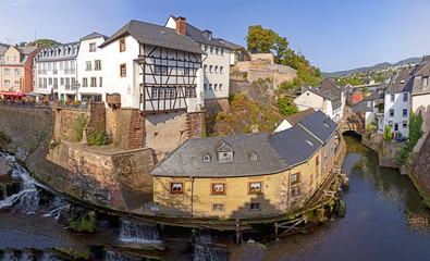 waterfall in the city center of Saarburg, Germany surrounded by houses on a hill