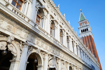 Fototapeta na wymiar National Marciana library facade and San Marco bell tower, clear blue sky in Venice, Italy