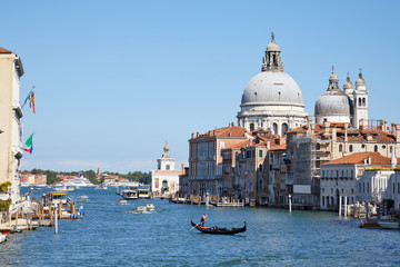 Fototapeta na wymiar Venice, Saint Mary of Health basilica and Grand Canal with gondola in Italy in a sunny summer day