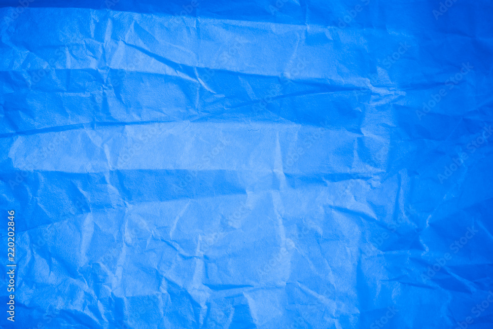 Wall mural Crumpled blue paper background.