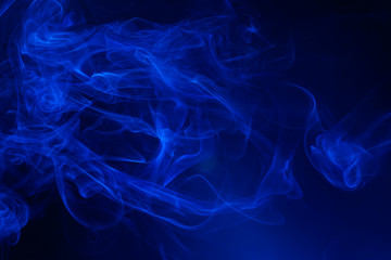Blue smoke on black background.