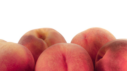 Close-up photo of five peach fruits isolated on white background