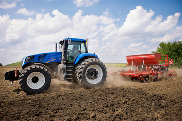 tractor plows a field