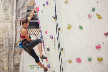 Photo of young athlete practicing on wall for rock climbing © Sergey Mironov