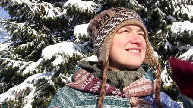 portrait of a girl on a background of snowy winter spruce, Russia