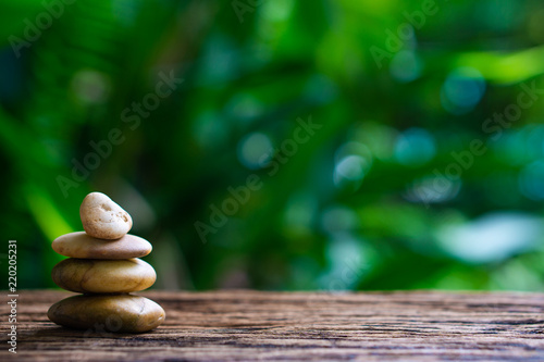 Balance Zen Stones On Wood With Green Nature Bokeh
