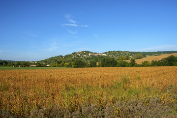 Fortified Penne d'Agenais and its hilltop Byzantine-Romanesque style Notre-Dame de Peyragude basilica with its silver dome oversses rural Agenais countryside in Lot et Garonne, France.