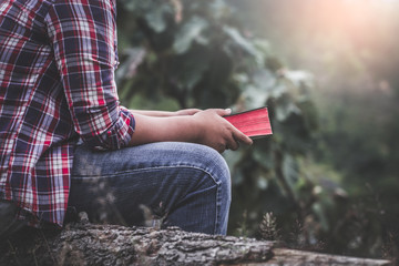 Close up hands of male holding Bible on mountain in morning