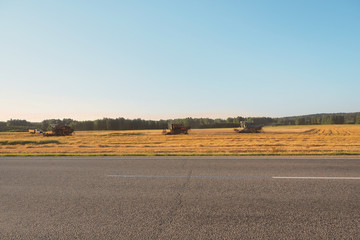 Fototapeta na wymiar Combine harvester harvest ripe wheat on field