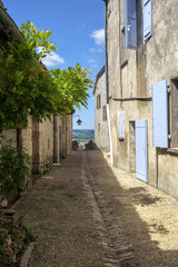 Fototapeta na wymiar Picturesque architecture in early summer sunshine in Pujols, Lot-et-Garonne, France. This historic village is a member of 