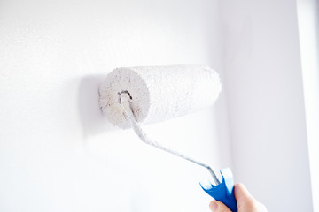 Wall painting with roller on white