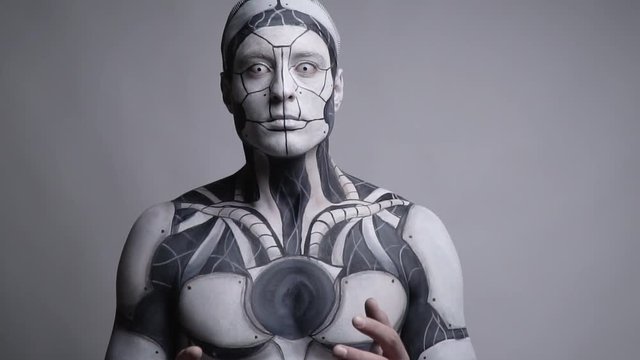 Surprised cyborg looks at his hands, bit slow motion