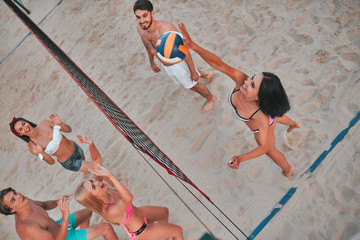 Friends playing volleyball