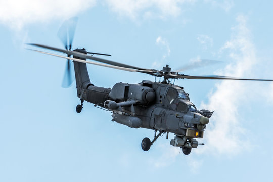 Military helicopter in the sky on a combat mission with weapons.