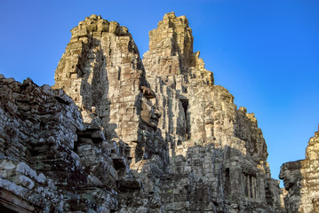 Stone face of Buddha on the ruins of the ancient temple of Bayon. Angkor Thom. Cambodia