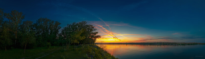 Sunset with traces of aircraft in the natural park "Donskoy". Volgograd region. Russia