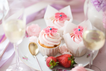 Beautiful cakes with cream and strawberries on a plate with a spoon.