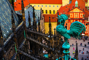 Weathercock on the St Vitus cathedral roof, Czech, Prague. Prague architecture, red roofs, weather vane shape of rooster.