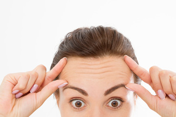 Macro Woman face with wrinkles on the forehead. Collagen and face injections concept. Menopause....