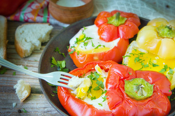 Tasty dish with fried eggs in yellow and red bell peppers.
