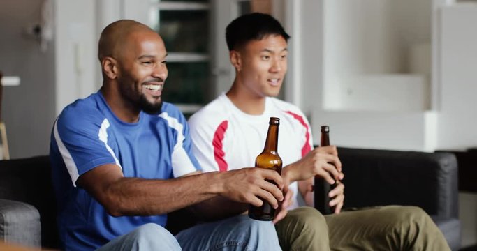 Male friends staying in to watch sports tv