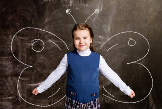  schoolgirl against chalkboard, with butterfly wings
