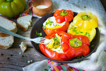 Tasty dish with fried eggs in yellow and red bell peppers.