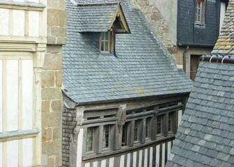 Roofs of old houses and chimneys in the fortress Mont Saint Mishel, Normandy, France