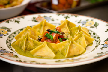 Plate of fresh ravioli in a pesto sauce..