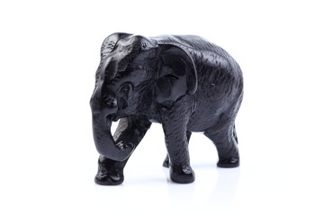 Fototapeta na wymiar Black elephant like wooden carving with white ivory. Stand on white background, Isolated, Art Model Thai Crafts, For decoration Like in the spa.