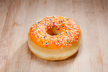 Single delicious donut on wood