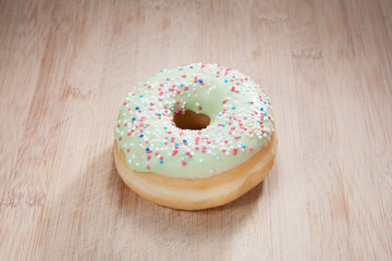 Single delicious donut on wood