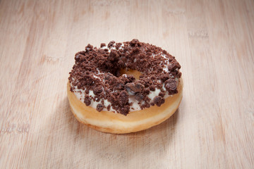 Single delicious donut on wood