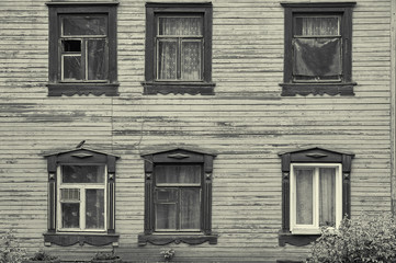 Old wooden house facade with six beautiful windows