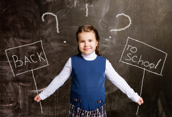 cute little schoolgirl against chalkboard, with  plate