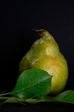 Fresh ripe organic pear on dark background, diet food