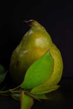 Fresh ripe organic pear on dark background, diet food