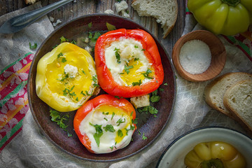 Delicious dish with fried eggs in yellow and red bell pepper