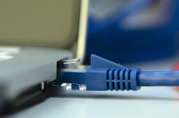 Closeup ethernet cable connected to the Lan port on laptop for computer network concept