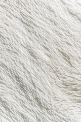 Fluffy plaid of polyester with a long heap gray. Comfortable home textiles. Background, texture