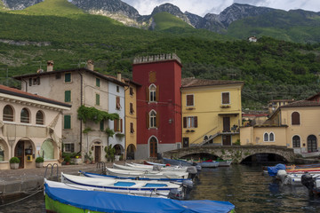 Malcasine village on the East side of Garda see with boats in harbor in forefront
