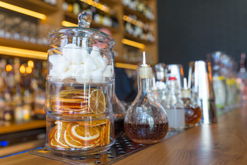 Classic bar counter with bottles in blurred background